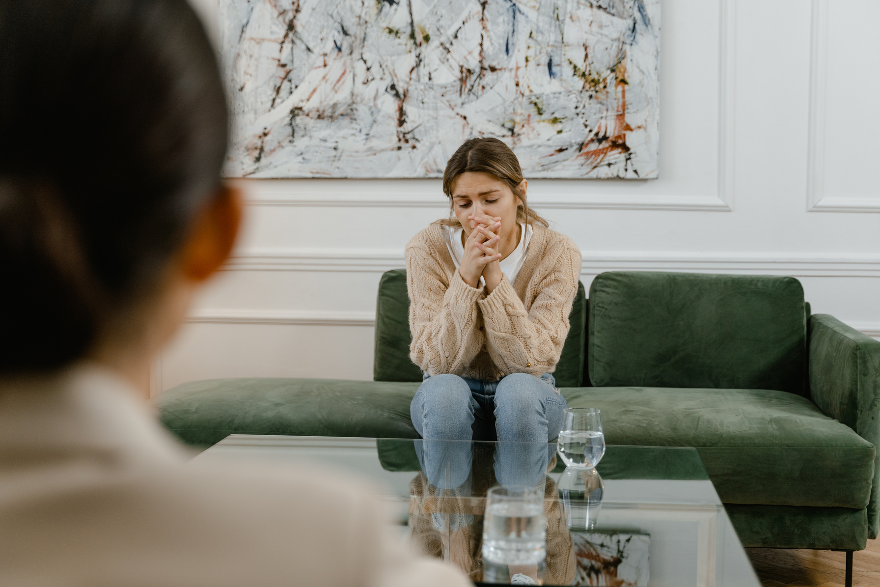 A Woman Wearing a Sweater Sitting on a Couch